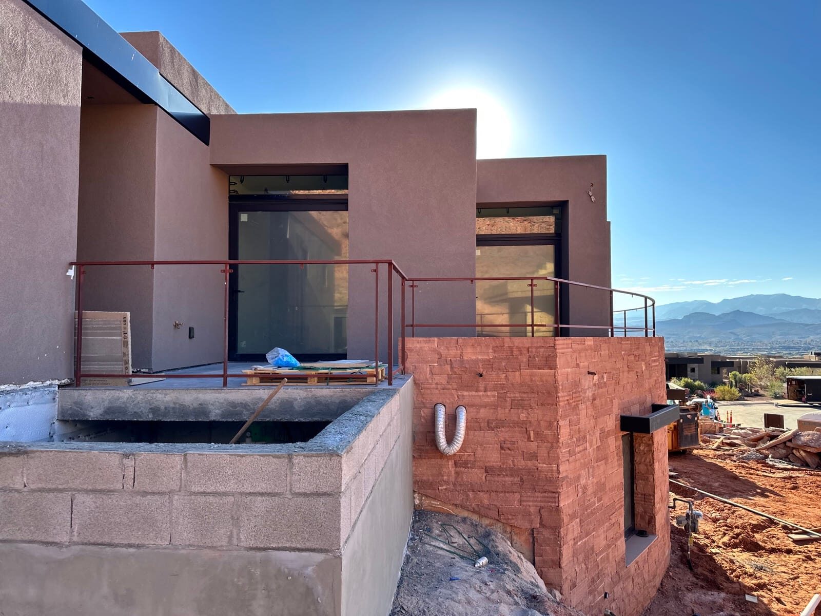 Custom radius steel railing following curved concrete at Entrada at Snow Canyon, close-up